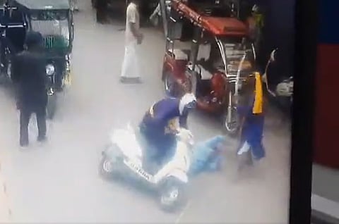 One assailant hits Thappar, while other lifts up the scooty.
